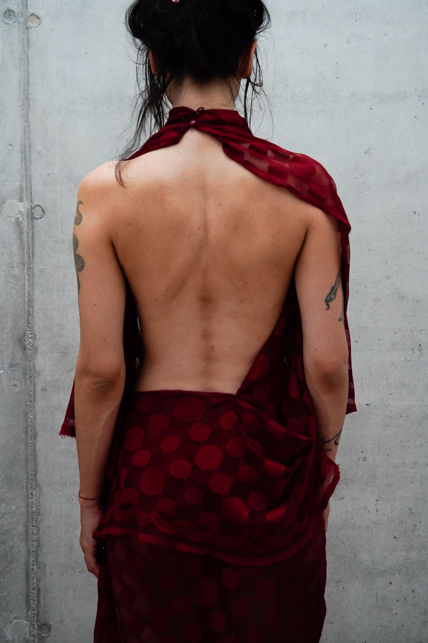 Red sheer check gown, draped at the hip with a pooled train