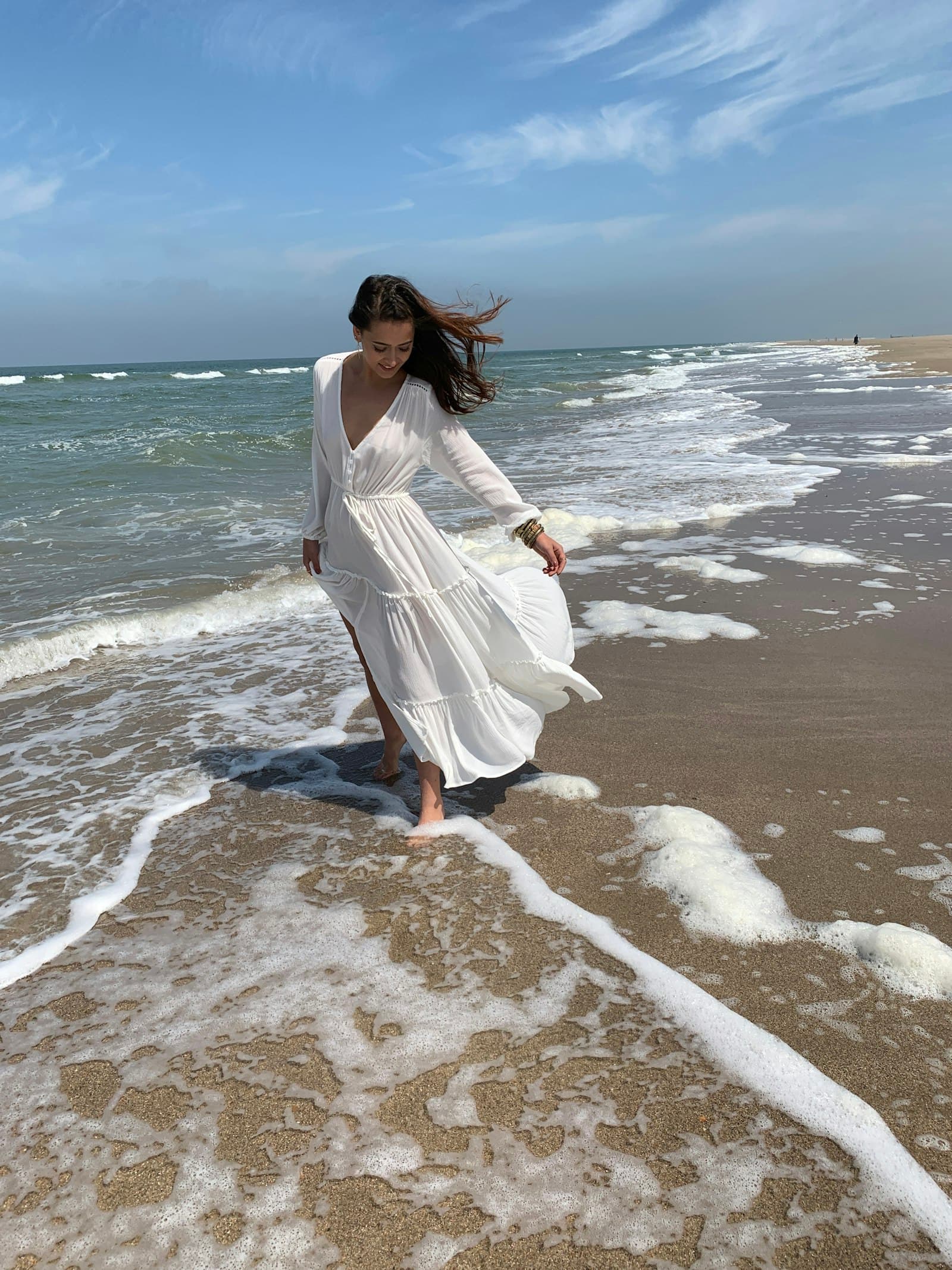 Woman wearing white maxi dress at the beach