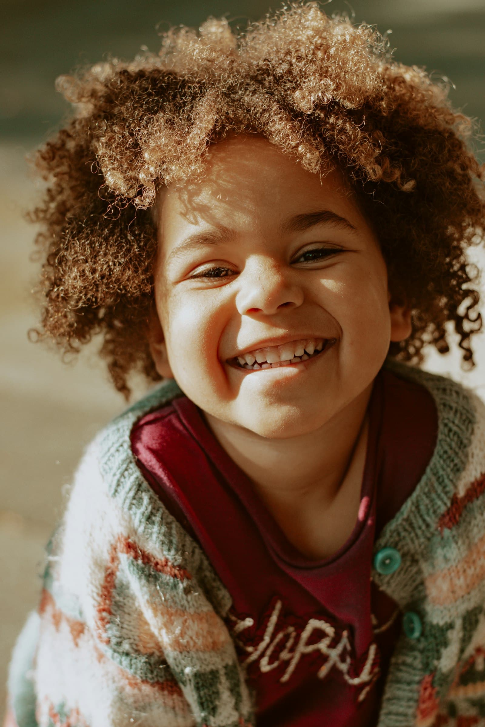 Girl in red and white knit sweater smiling